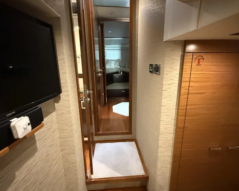 Slide: The Image of Interior hallway of 2016 Tiara Yachts 50 Coupe, featuring wood finishes and modern design. - 18