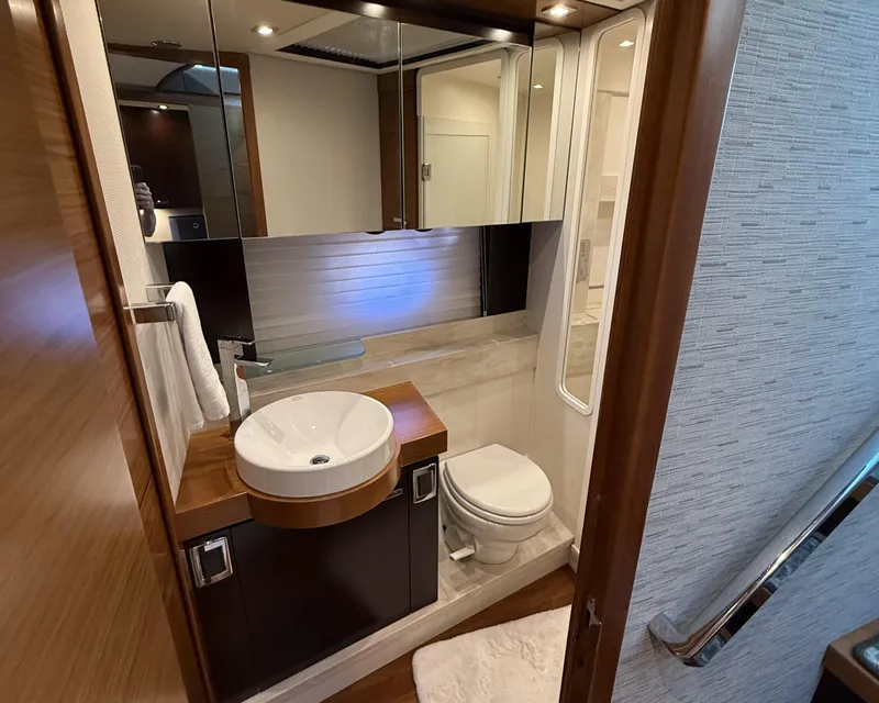 Slide: The Image of Luxurious interior of 2016 Tiara Yachts 50 Coupe with modern wood cabinetry and cozy bedding. - 21