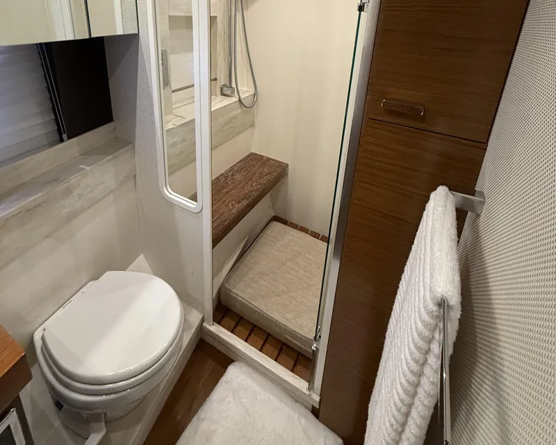 Slide: The Image of Laundry area in 2016 Tiara Yachts 50 Coupe with stacked washer and dryer. - 23