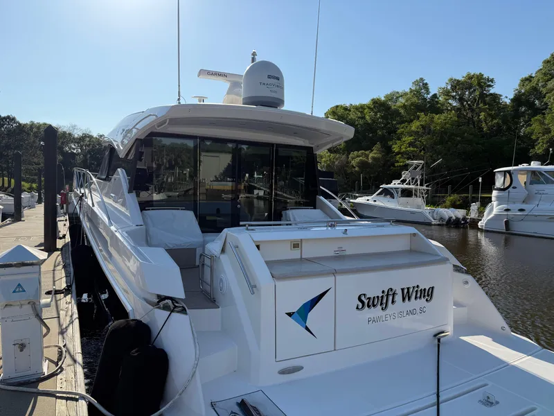 Slide: The Image of 2016 Tiara Yachts 50 Coupe docked, featuring "Swift Wing" branding, Pawleys Island, SC. - 8