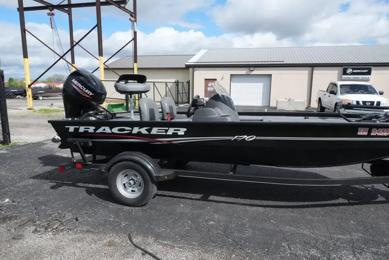 Slide: The Image of 2023 Tracker Pro 170 boat on trailer, parked outdoors under a cloudy sky. - 5