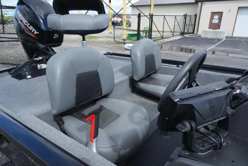 Slide: The Image of 2023 Tracker Pro 170 boat interior with gray seats and Mercury engine. - 7