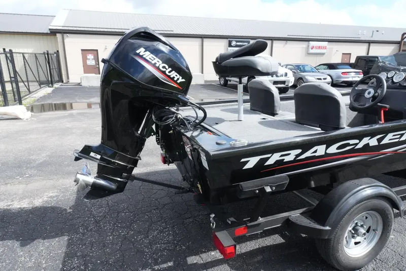 Slide: The Image of 2023 Tracker Pro 170 boat with Mercury outboard motor in a parking lot. - 8