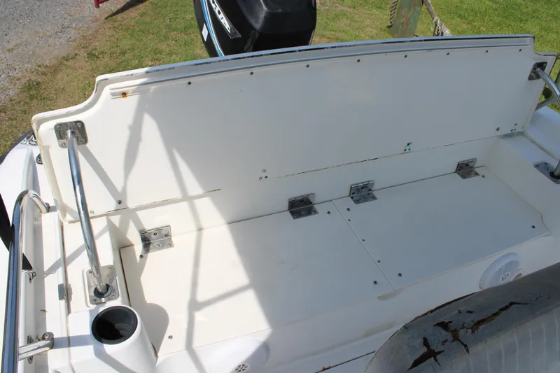 Slide: The Image of 2005 Boston Whaler 180 Dauntless boat seating area with storage compartments. - 11