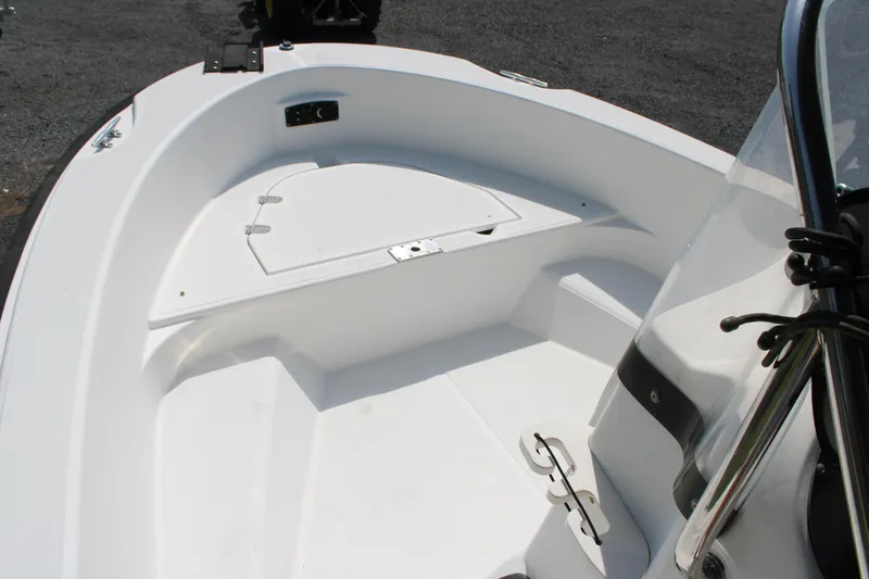 Slide: The Image of 2005 Boston Whaler 180 Dauntless boat interior, featuring a clean, white deck and storage compartment. - 13