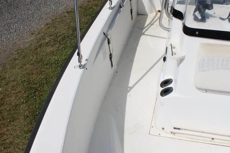 Slide: The Image of 2005 Boston Whaler 180 Dauntless boat interior, featuring seating and rod holders. - 19