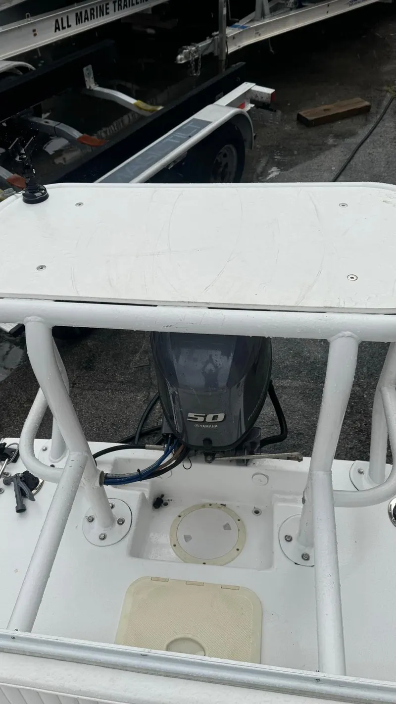 Slide: The Image of 2022 Salt Creek 1500 boat with outboard motor, docked at a marina. - 12