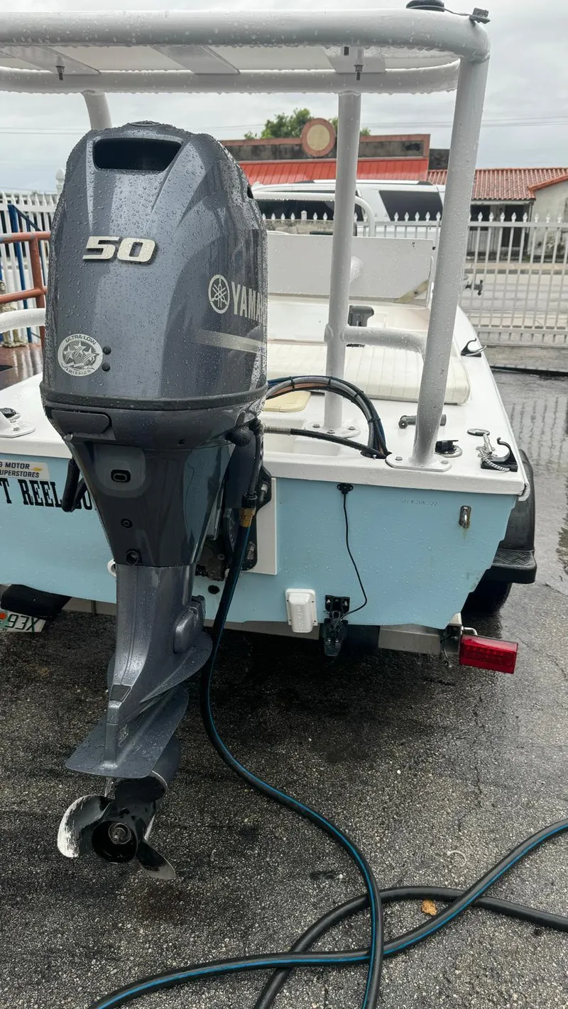 Slide: The Image of 2022 Salt Creek 1500 boat with Yamaha 50 outboard motor, docked on wet pavement. - 13