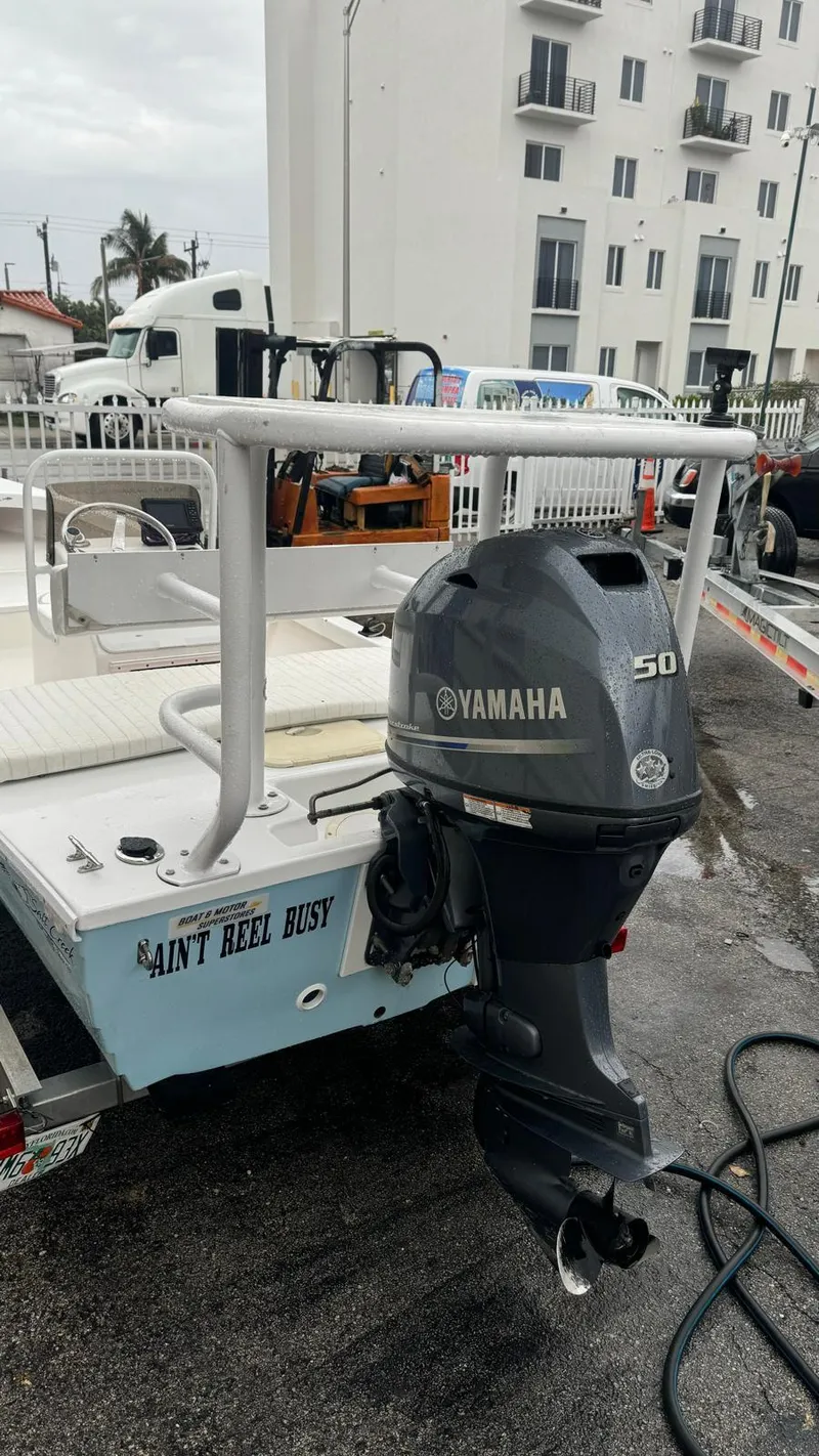 Slide: The Image of 2022 Salt Creek 1500 boat with Yamaha 50 outboard motor, docked near modern buildings. - 15