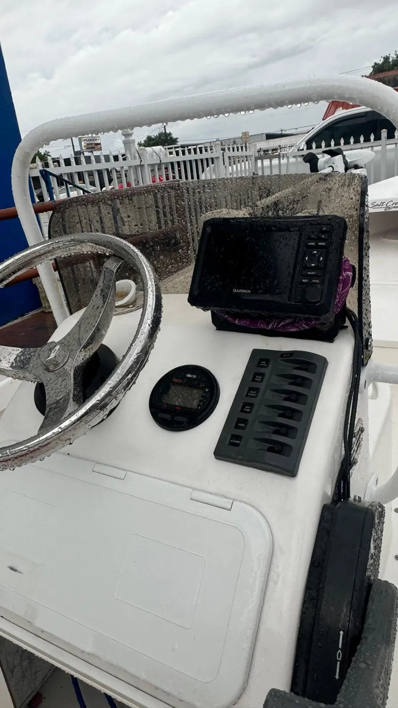 Slide: The Image of Control panel of 2022 Salt Creek 1500 boat with steering wheel and navigation system. - 3