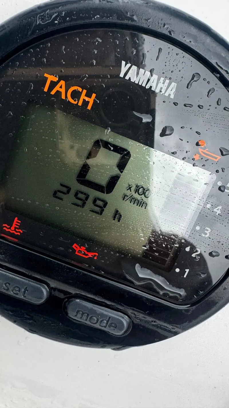 Slide: The Image of Close-up of a Yamaha tachometer displaying 299 hours, wet with water droplets. - 4