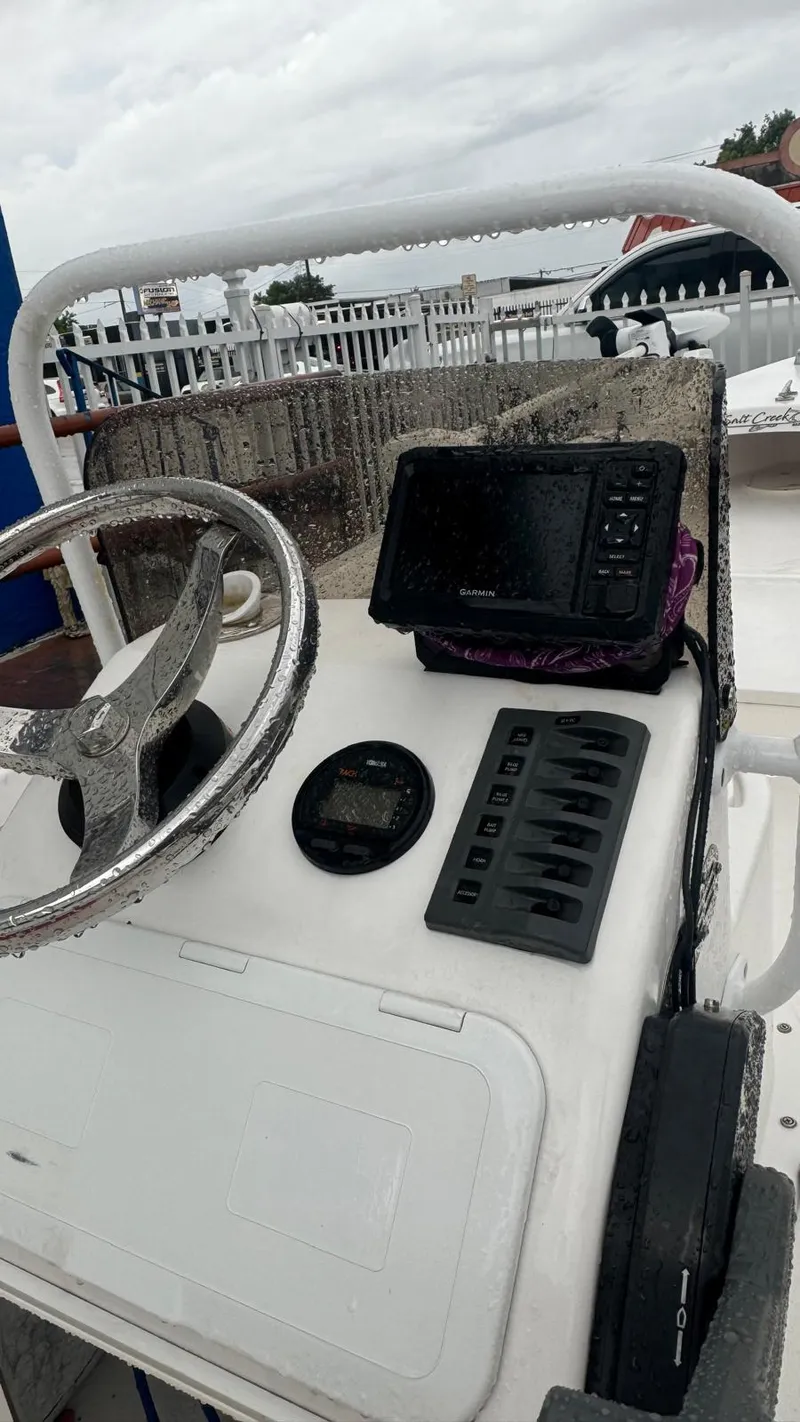 Slide: The Image of Control panel of a 2022 Salt Creek 1500 boat with steering wheel and navigation equipment. - 5