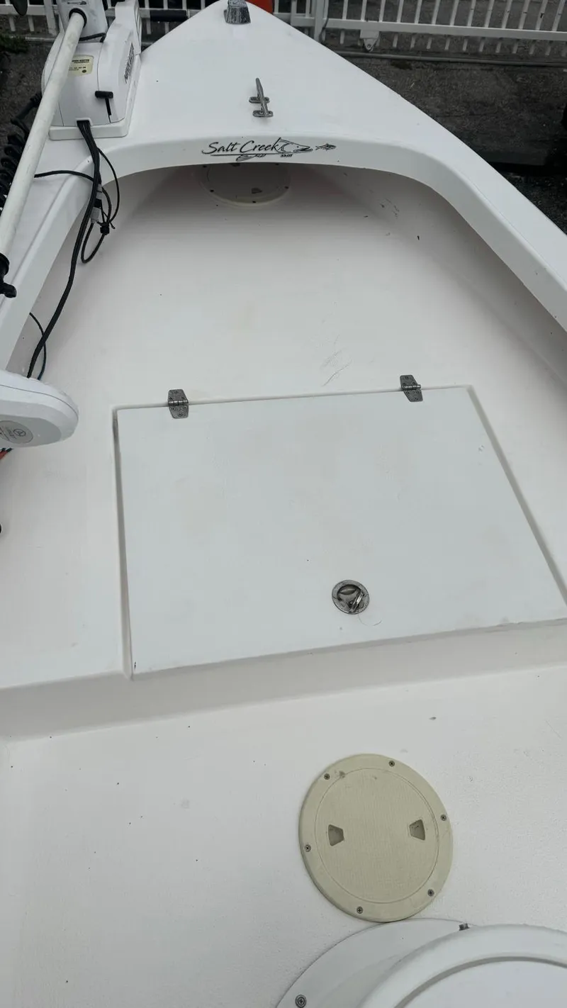 Slide: The Image of 2022 Salt Creek 1500 boat deck with storage hatch and clean white finish. - 7