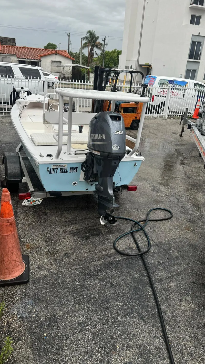 Slide: The Image of 2022 Salt Creek 1500 boat with Yamaha motor, parked on a trailer in a lot. - 9