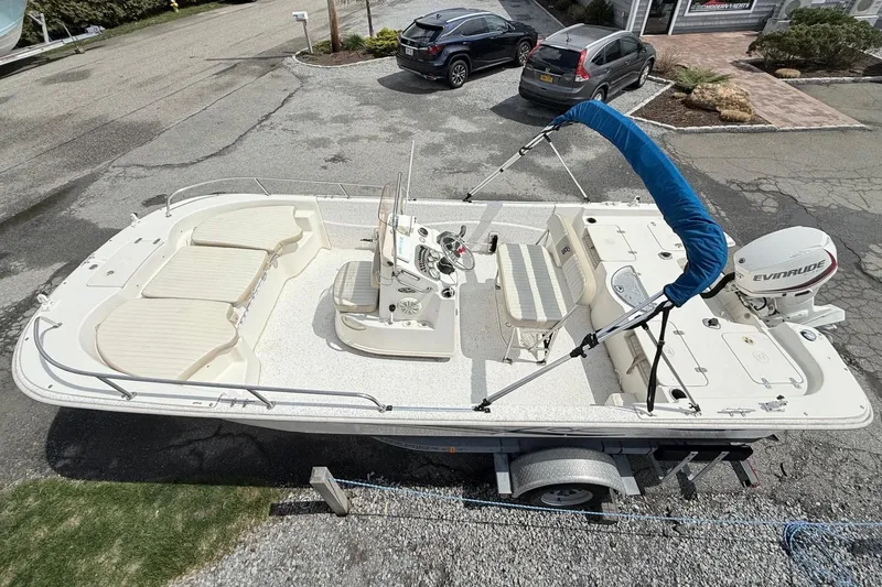 Slide: The Image of 2018 Carolina Skiff 198 DLV boat with Evinrude motor on trailer, parked outdoors. - 4