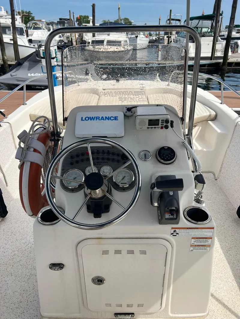 Slide: The Image of 2018 Carolina Skiff 198 DLV boat console with steering wheel and navigation equipment. - 10