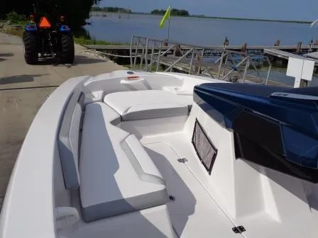 Slide: The Image of 2016 Scarab 165G boat interior with white seating, docked near a lake. - 12