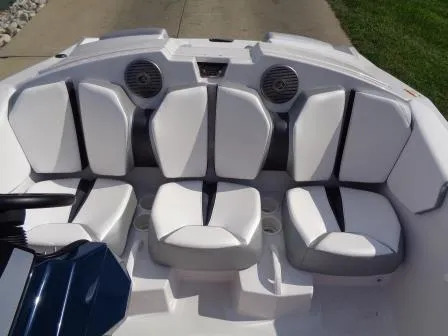 Slide: The Image of 2016 Scarab 165G boat interior with white cushioned seating and built-in speakers. - 9