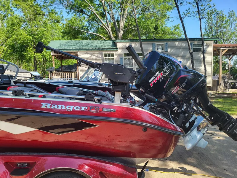 Slide: The Image of 2015 Ranger 620FS Fisherman boat with motor, parked outdoors near a house. - 3