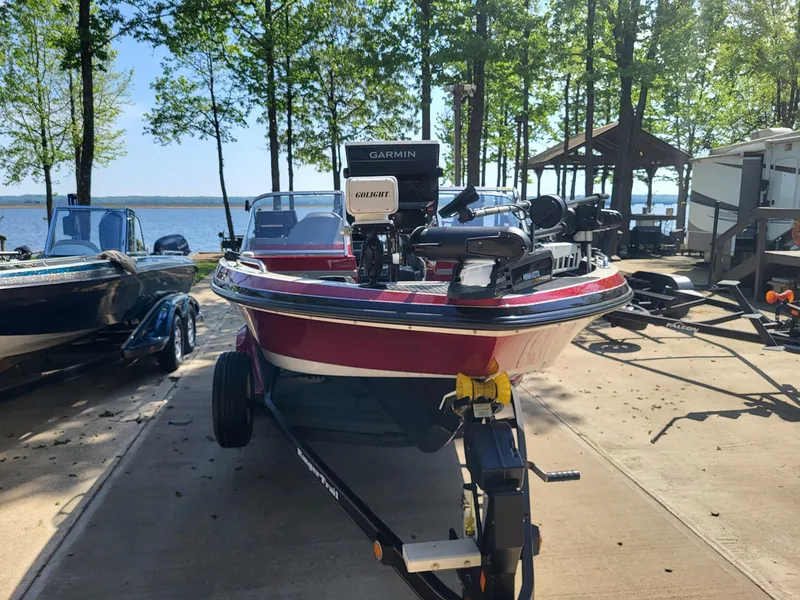 Slide: The Image of 2015 Ranger 620FS Fisherman boat on trailer by lakeside, surrounded by trees and vehicles. - 6