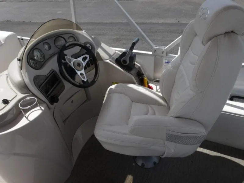 Slide: The Image of 2008 Crest III XRS boat cockpit with steering wheel and captain's chair. - 10