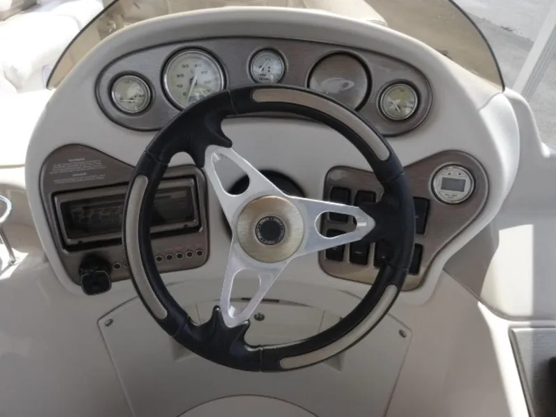 Slide: The Image of Steering wheel and dashboard of 2008 Crest III XRS boat, featuring gauges and controls. - 11