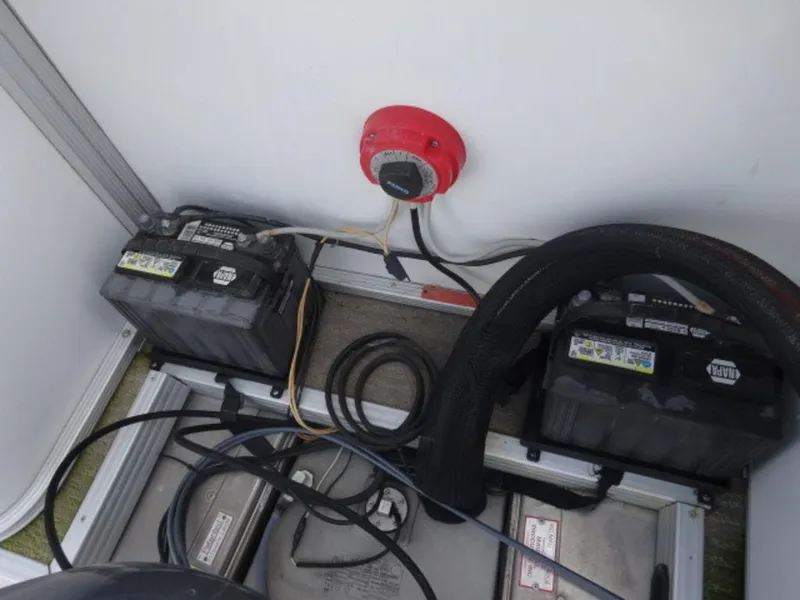 Slide: The Image of Two car batteries with cables and a red switch in a Crest III XRS, 2008 model. - 12