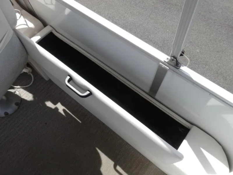 Slide: The Image of Storage compartment in a 2008 Crest III XRS boat, featuring a sleek handle design. - 13