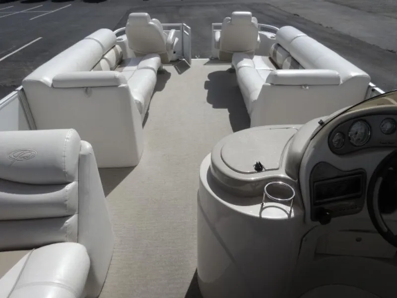 Slide: The Image of 2008 Crest III XRS pontoon boat interior with white seating and helm. - 14