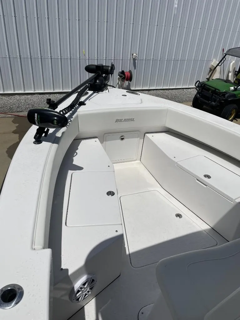 Slide: The Image of 2024 Reef Runner 230 XO boat interior with seating and equipment. - 17