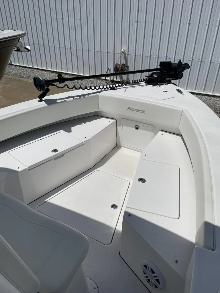 Slide: The Image of 2024 Reef Runner 230 XO boat interior with seating and mounted equipment. - 18