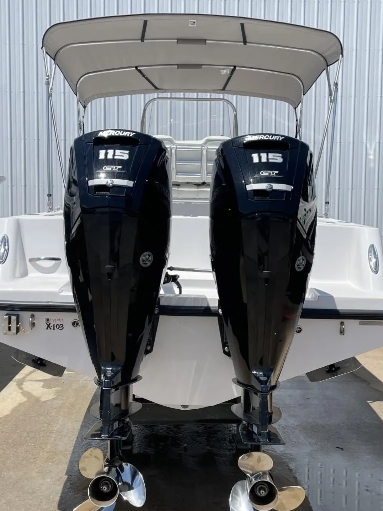 Slide: The Image of 2024 Reef Runner 230 XO boat with dual Mercury 115 engines, rear view. - 20