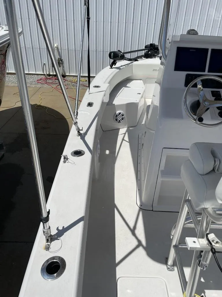 Slide: The Image of 2024 Reef Runner 230 XO boat interior with steering wheel and seating. - 23