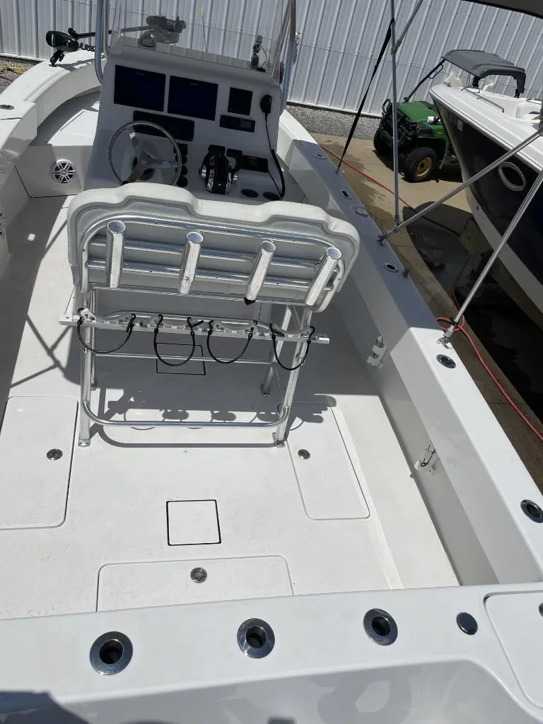 Slide: The Image of 2024 Reef Runner 230 XO boat interior with seating and control panel. - 25