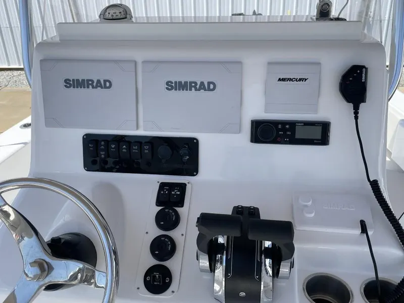 Slide: The Image of Control panel of 2024 Reef Runner 230 XO boat with Simrad and Mercury electronics. - 34