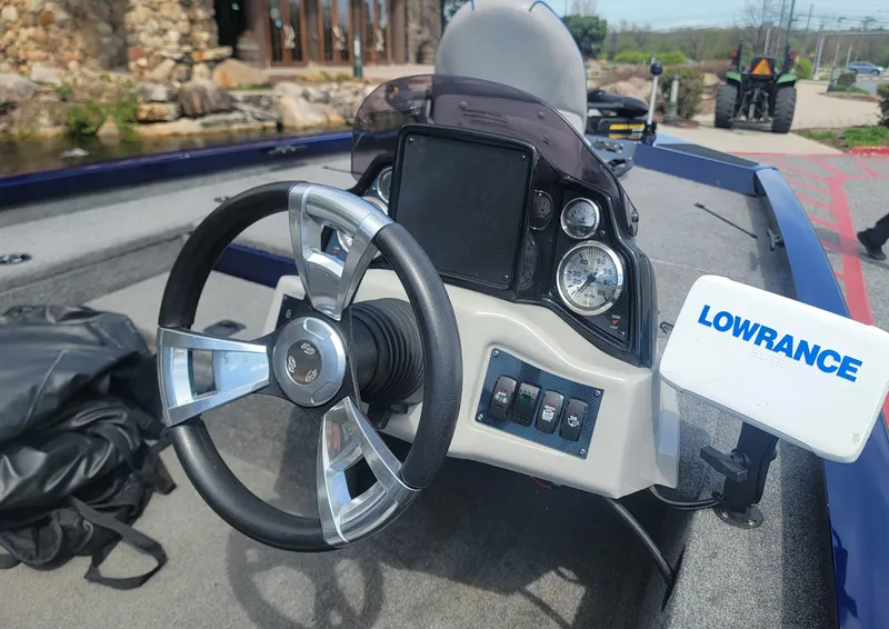 Slide: The Image of 2018 G3 Sportsman 17 boat dashboard with steering wheel and Lowrance fish finder. - 3