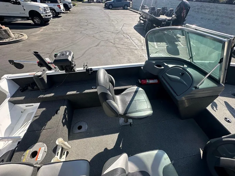 Slide: The Image of 2011 Lund 1625 Rebel XL Sport boat interior with seating and control panel. - 11