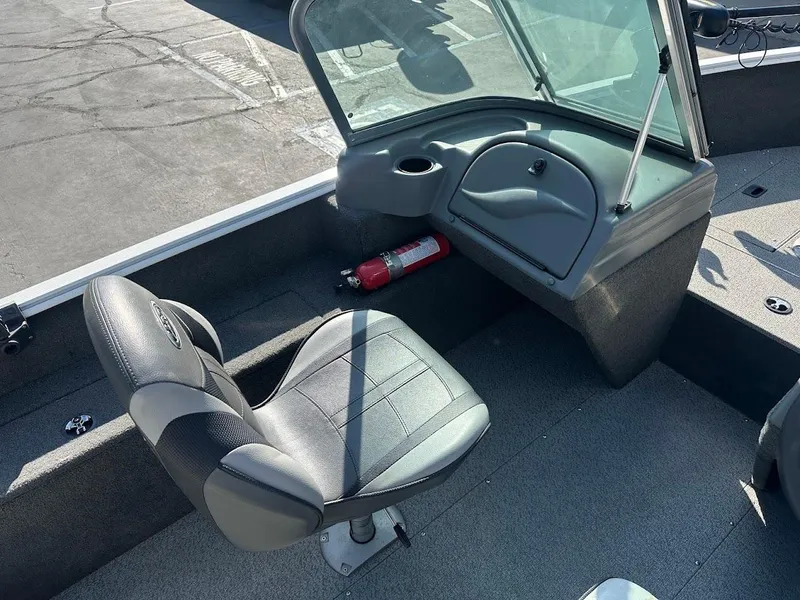 Slide: The Image of 2011 Lund 1625 Rebel XL Sport boat interior with seat and fire extinguisher. - 12