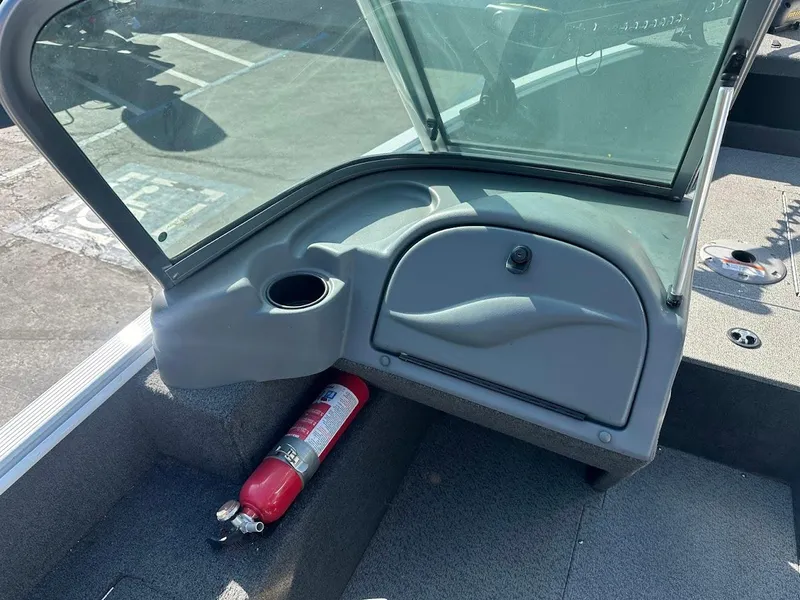 Slide: The Image of 2011 Lund 1625 Rebel XL Sport boat interior with windshield and fire extinguisher. - 13