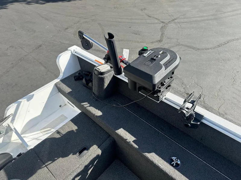 Slide: The Image of 2011 Lund 1625 Rebel XL Sport boat interior with fishing equipment and motor. - 15