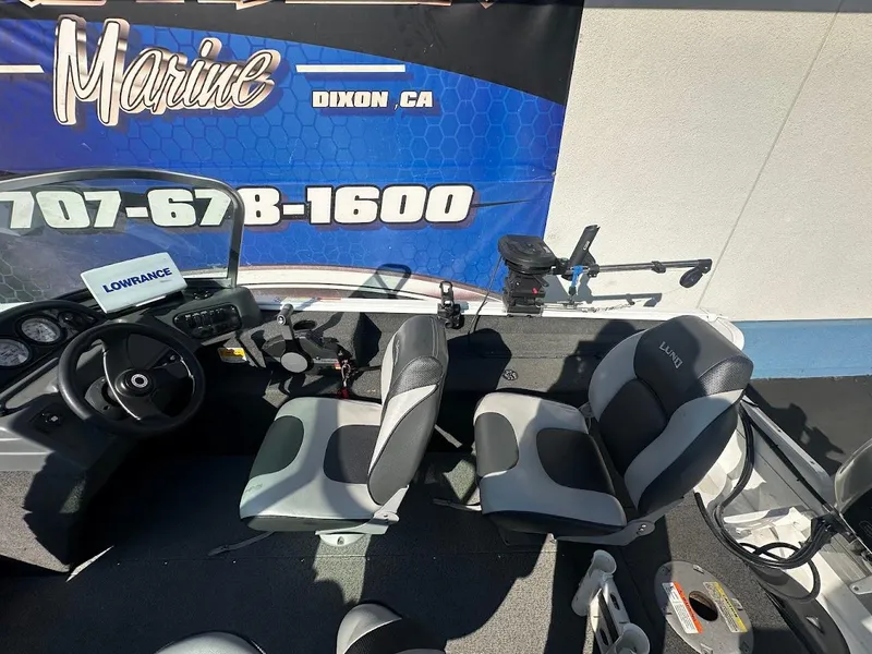 Slide: The Image of 2011 Lund 1625 Rebel XL Sport boat interior with seats and steering wheel. - 18