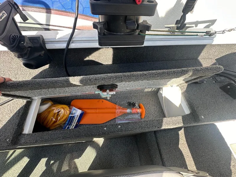 Slide: The Image of 2011 Lund 1625 Rebel XL Sport boat storage compartment with safety equipment and accessories. - 23