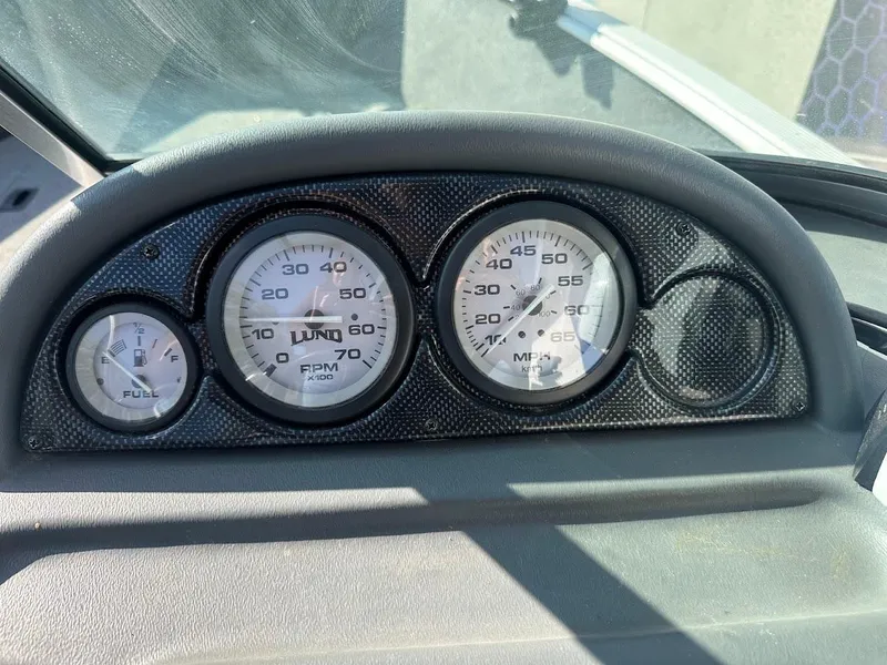 Slide: The Image of Dashboard of a 2011 Lund 1625 Rebel XL Sport boat showing fuel, RPM, and MPH gauges. - 26