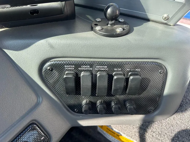 Slide: The Image of Control panel of a 2011 Lund 1625 Rebel XL Sport boat with labeled switches. - 28