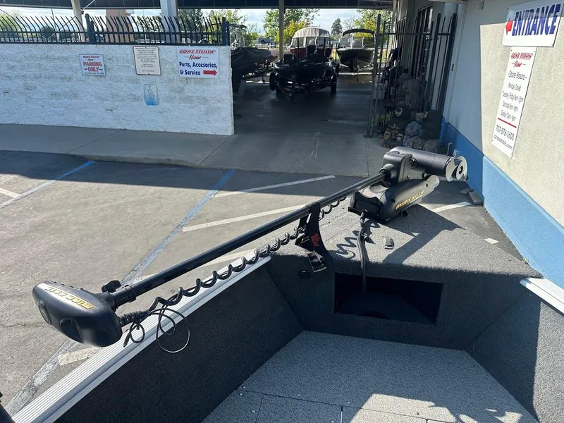 Slide: The Image of 2011 Lund 1625 Rebel XL Sport boat with trolling motor in parking lot. - 31