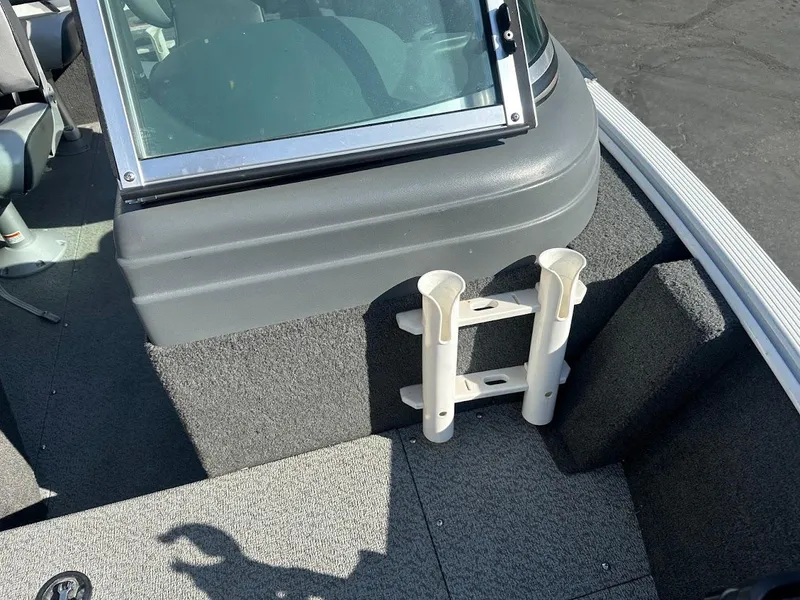 Slide: The Image of 2011 Lund 1625 Rebel XL Sport boat interior with rod holders and windshield. - 36