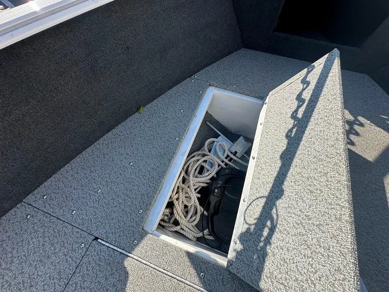 Slide: The Image of 2011 Lund 1625 Rebel XL Sport boat storage compartment with ropes and equipment. - 39