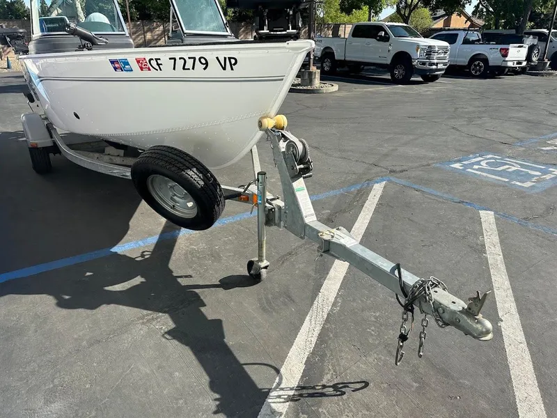 Slide: The Image of 2011 Lund 1625 Rebel XL Sport boat on trailer in parking lot. - 4