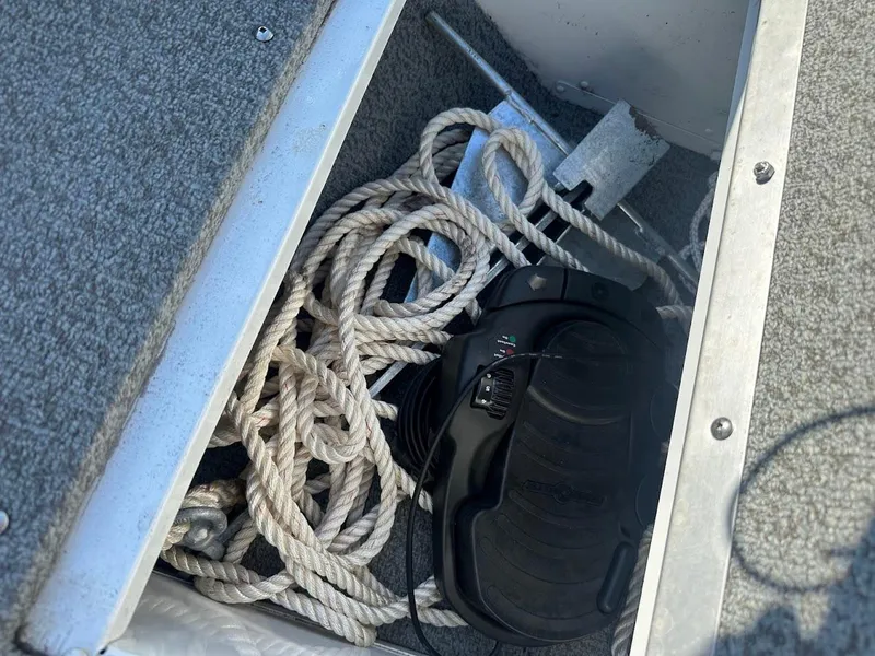 Slide: The Image of Storage compartment in a 2011 Lund 1625 Rebel XL Sport boat with rope and equipment. - 40