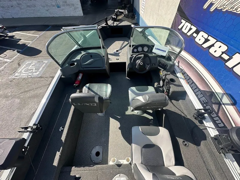 Slide: The Image of 2011 Lund 1625 Rebel XL Sport boat interior with seating and control panel. - 9